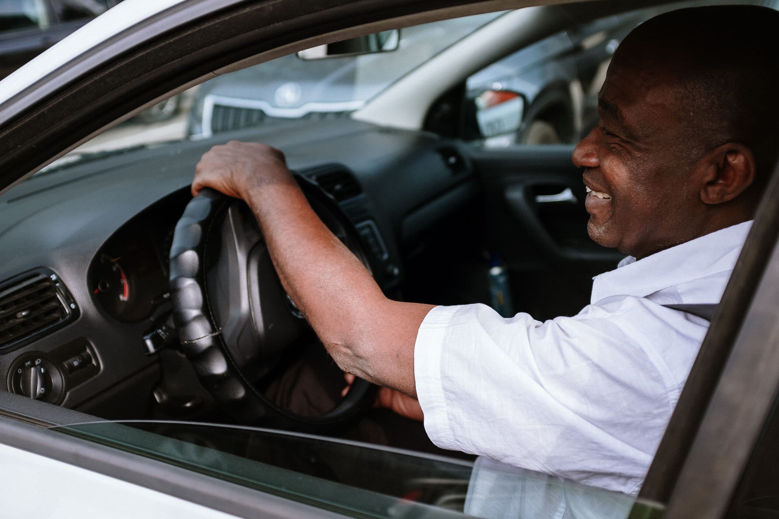 Smiling owner at the wheel of his own car